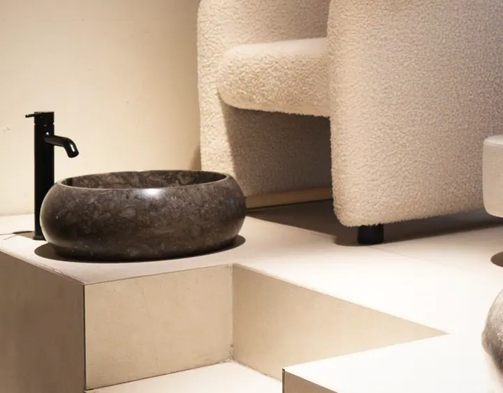 The dark stone basin in the treatment room, the highest-contrast object in the clinic.