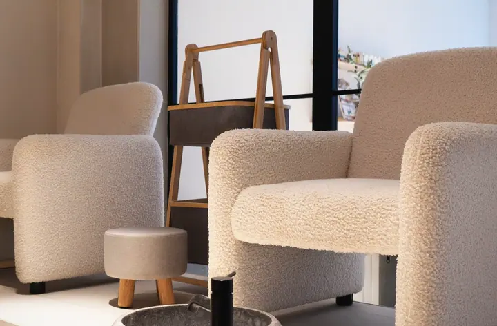 The bouclé chairs in the lounge, which is where a consultation actually happens.